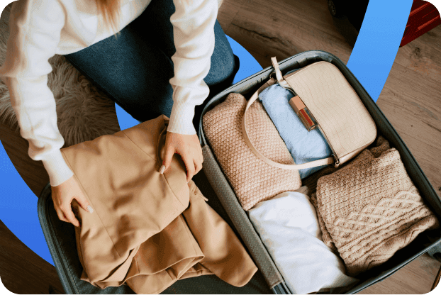 A traveller packing her suitcase